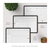 Set of planner sheets with text on a white surface with a plant and fruit.